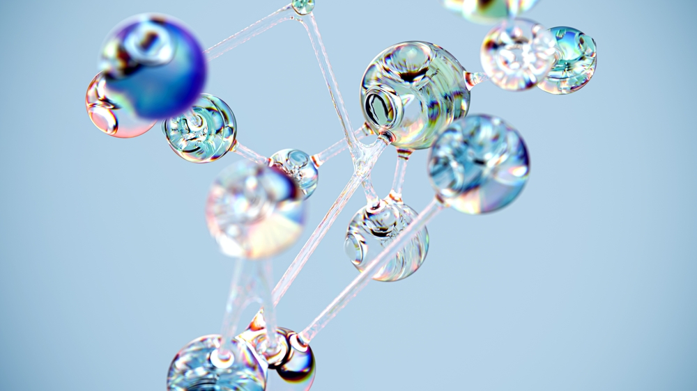 Transparente Glaskugeln die mit dünnen Glasstegen verbunden sind auf hellblauen Hintergrund